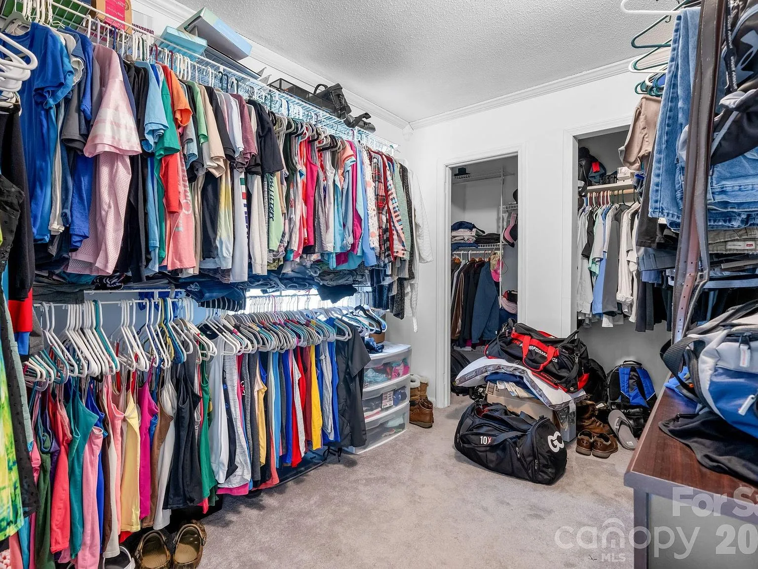Expansive walk-in closet with wire shelving throughout