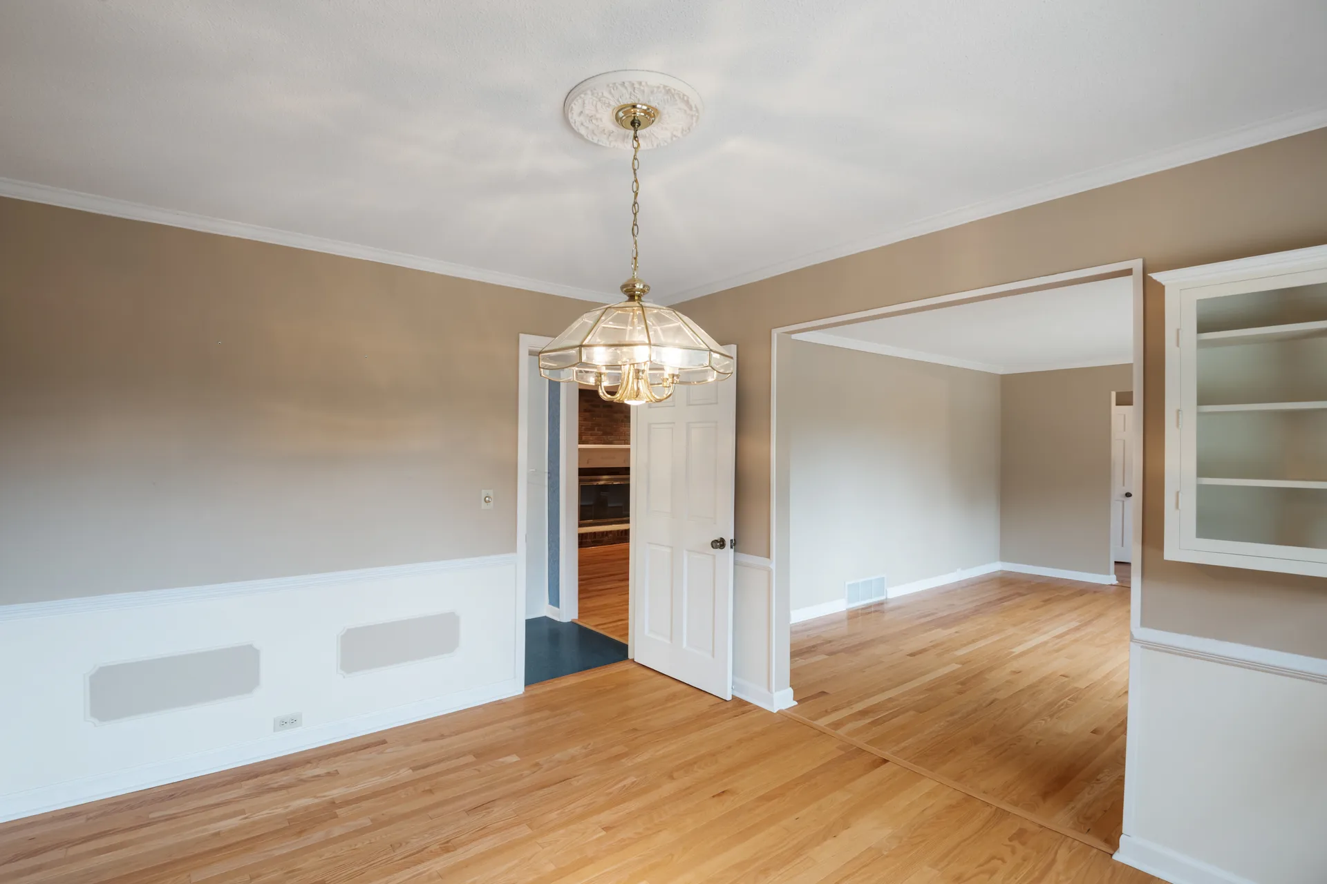 Dining room with white wainscoting and a white built-in cabinet