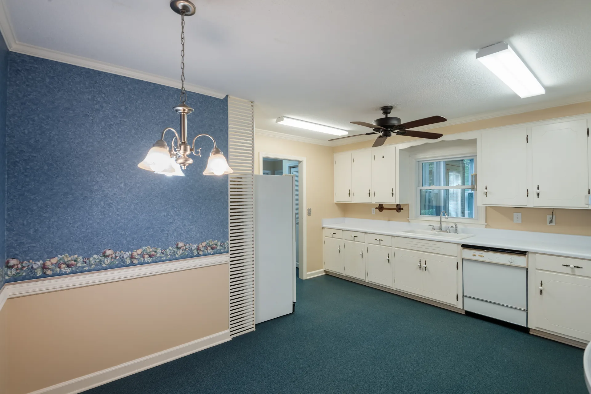 Kitchen with white cabinetry and an adjoining dining area