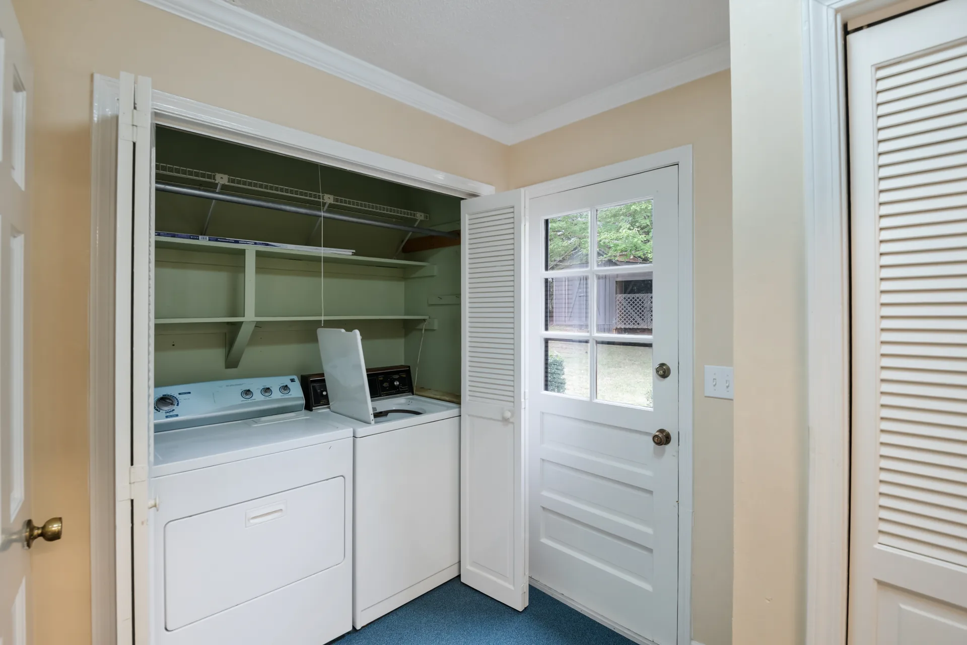 Laundry room with stacked washer and dryer in a closet