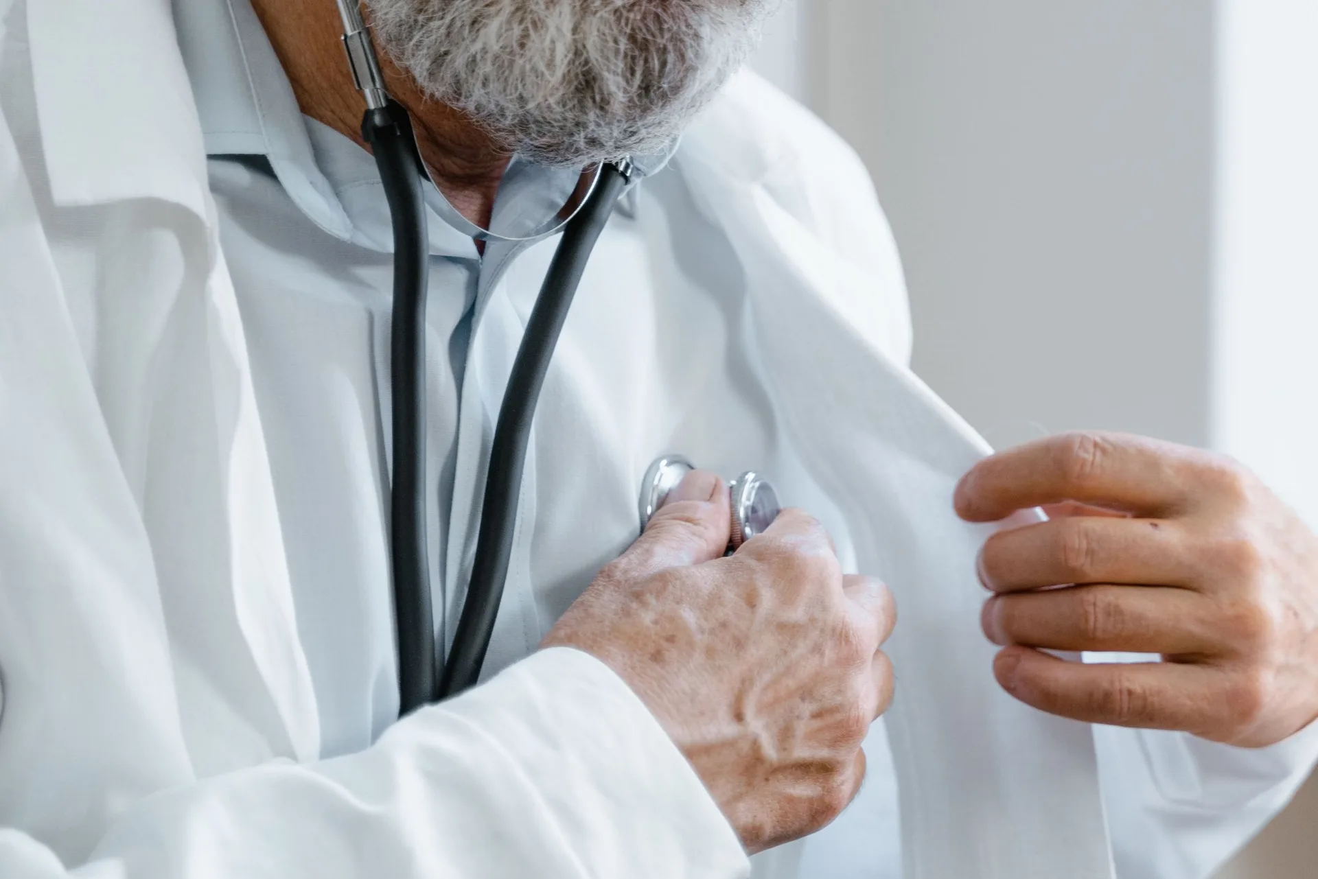 A TruHealth provider performing an exam with a stethoscope during a patient visit