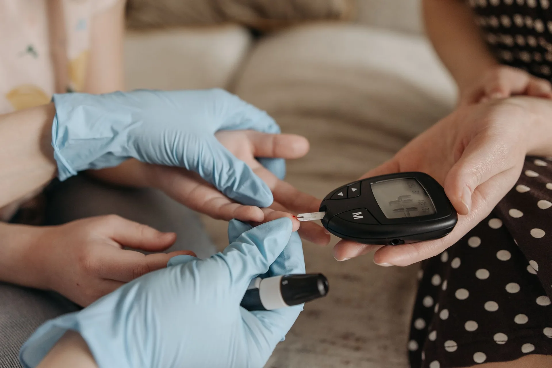 A provider performing a blood glucose test during a diabetes management visit at TruHealth