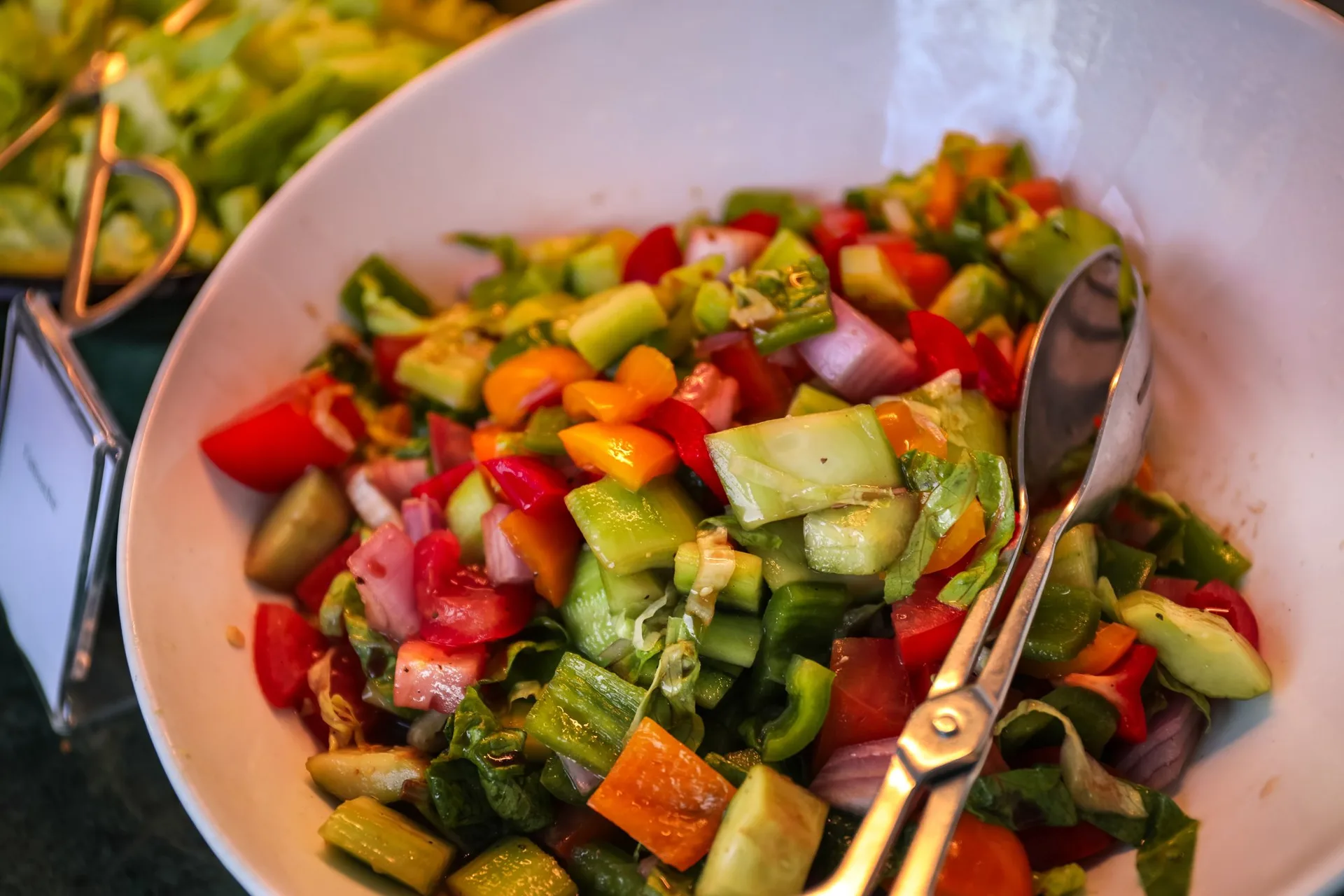 A fresh chopped vegetable salad with tomatoes, cucumbers, and peppers, part of a balanced approach to weight management