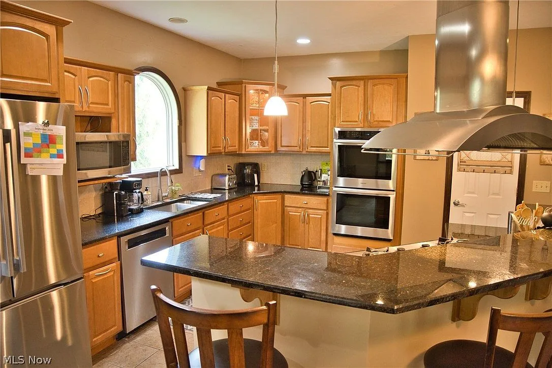 Gourmet kitchen with oak cabinetry and granite countertops