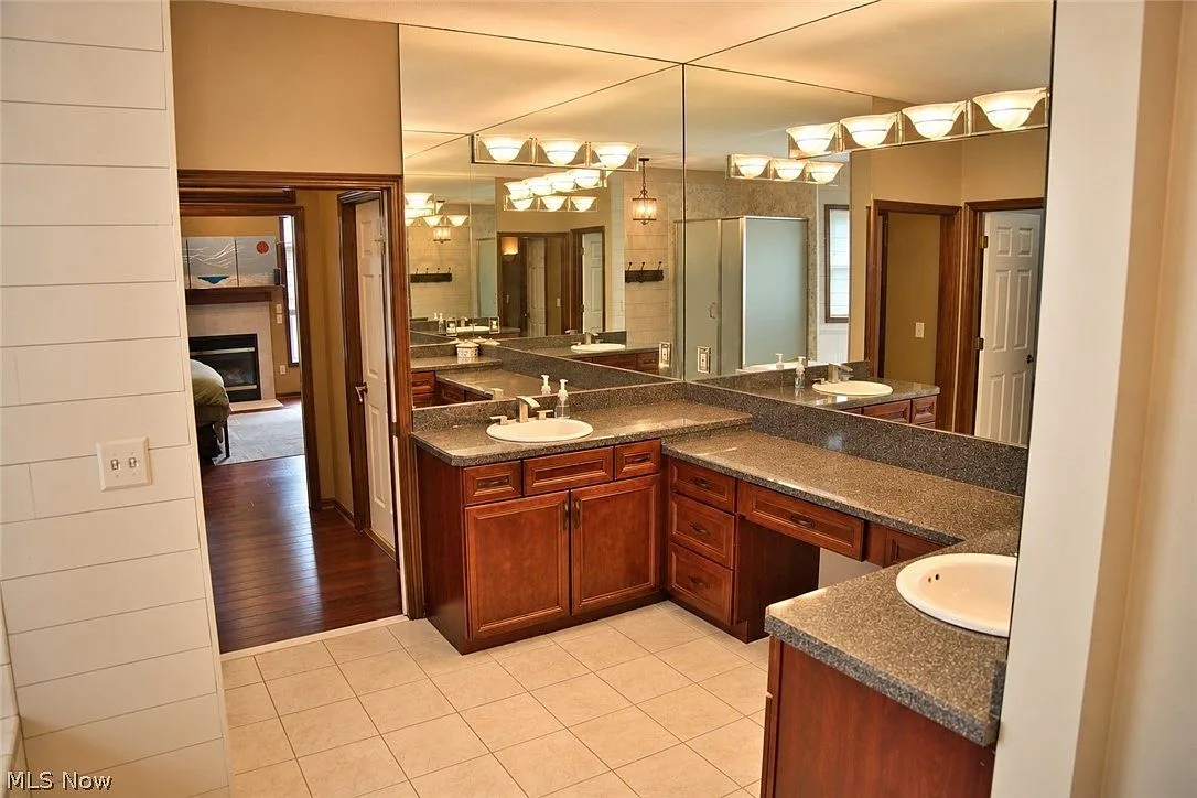 Primary bathroom vanity with dual sinks and granite counters