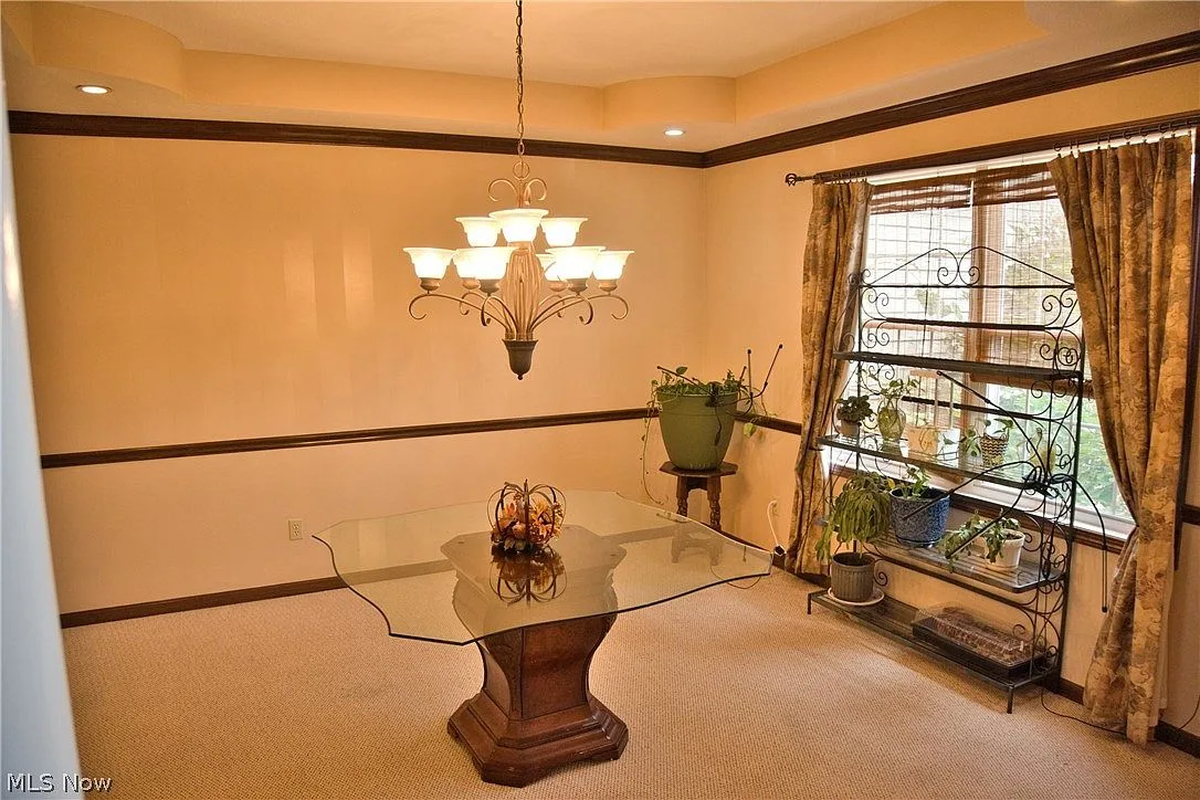 Formal dining room with crown molding and a chair rail