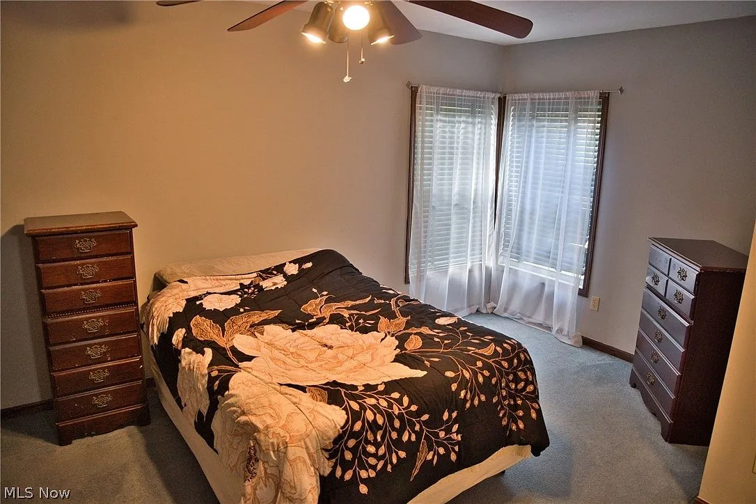 Secondary bedroom with corner windows and neutral walls