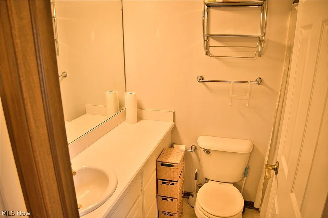 Half bathroom with a white vanity and large mirror