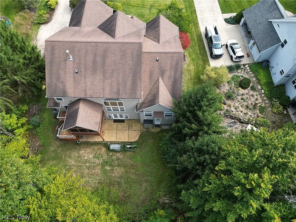 Top-down aerial view of the rear of the property with the three-car garage