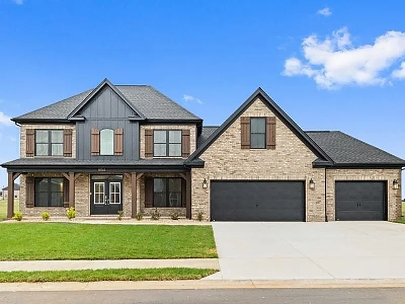 Front exterior with attached three-car garage
