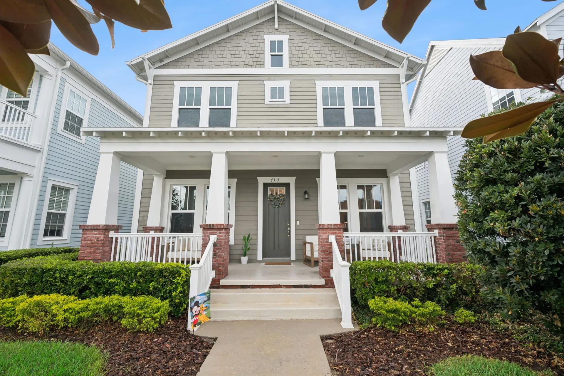Front facade of 7313 Tidepool Pl in Celebration, Florida, with its Craftsman-style porch and full elevation