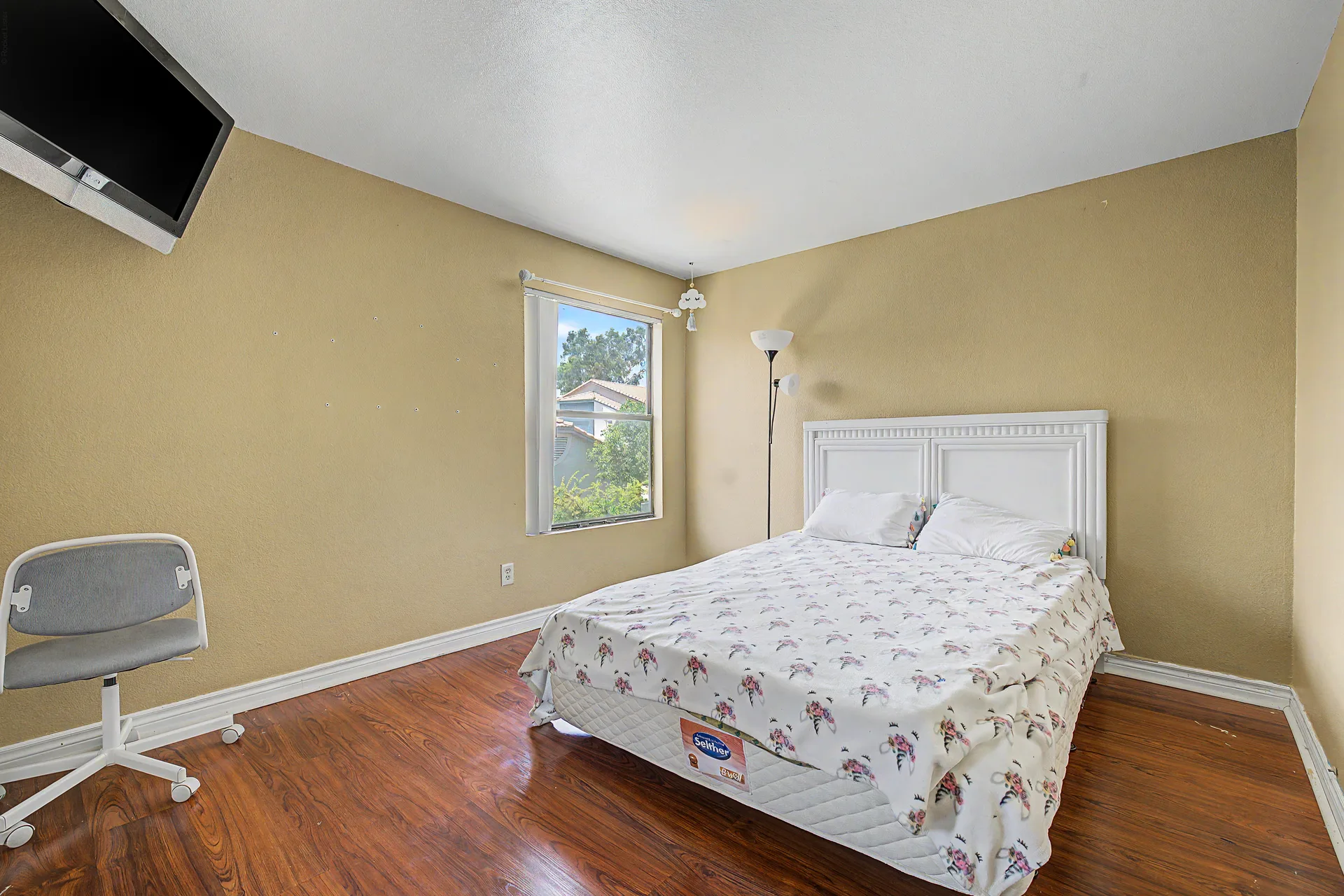 Guest bedroom with neutral walls and a window with natural light