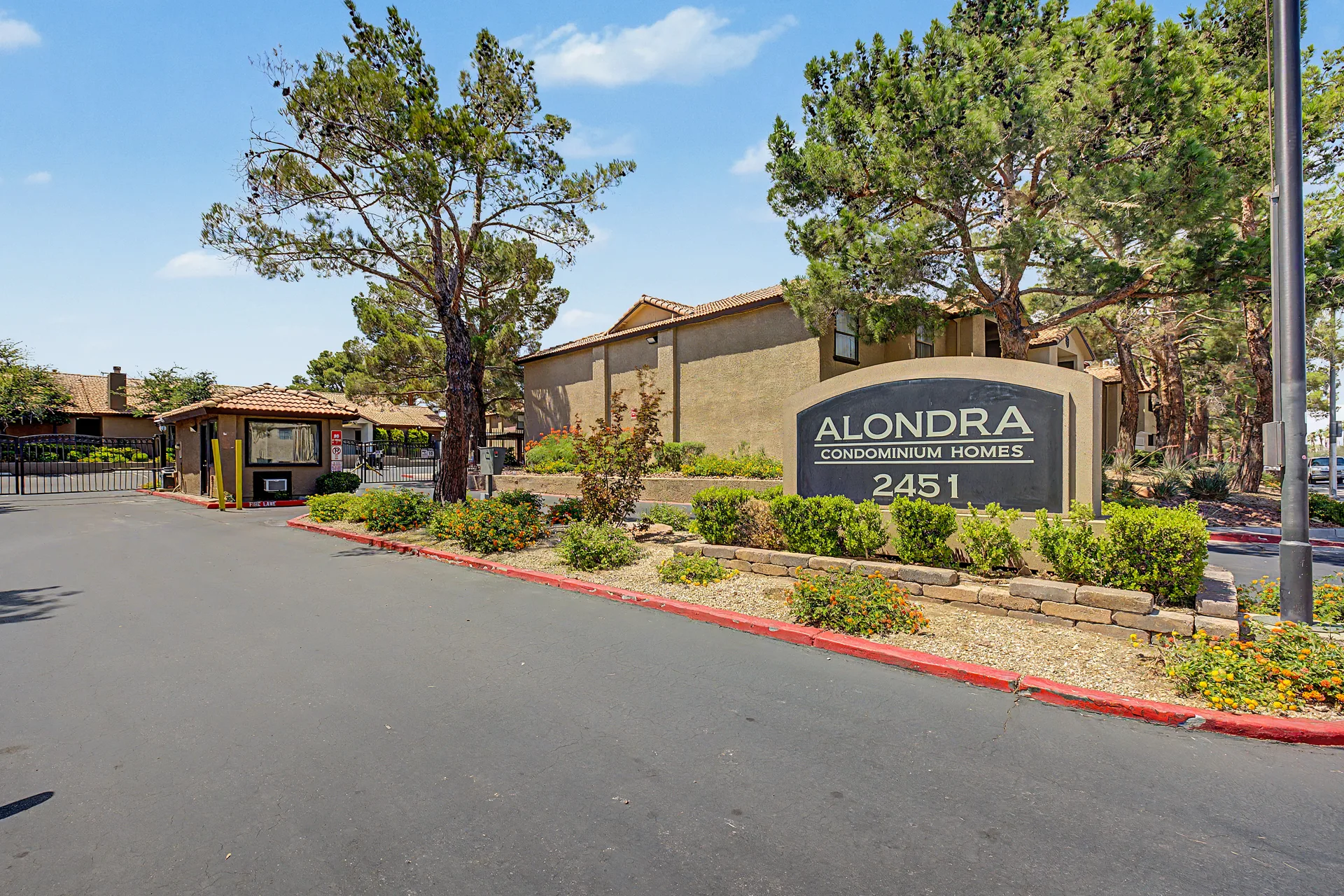 Gated entrance and monument sign for Alondra Condominium Homes
