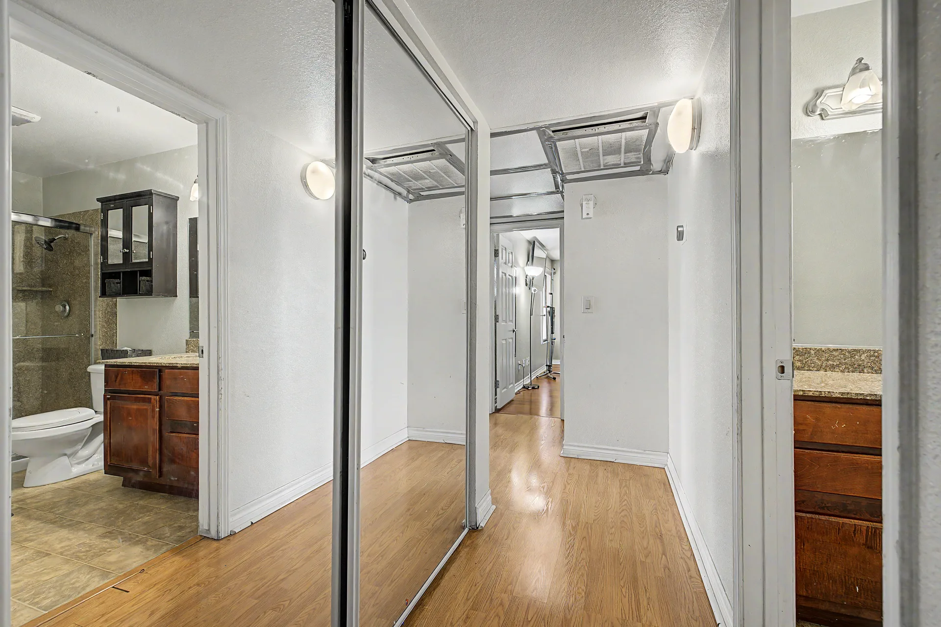 Interior hallway with full-length sliding mirror closet doors