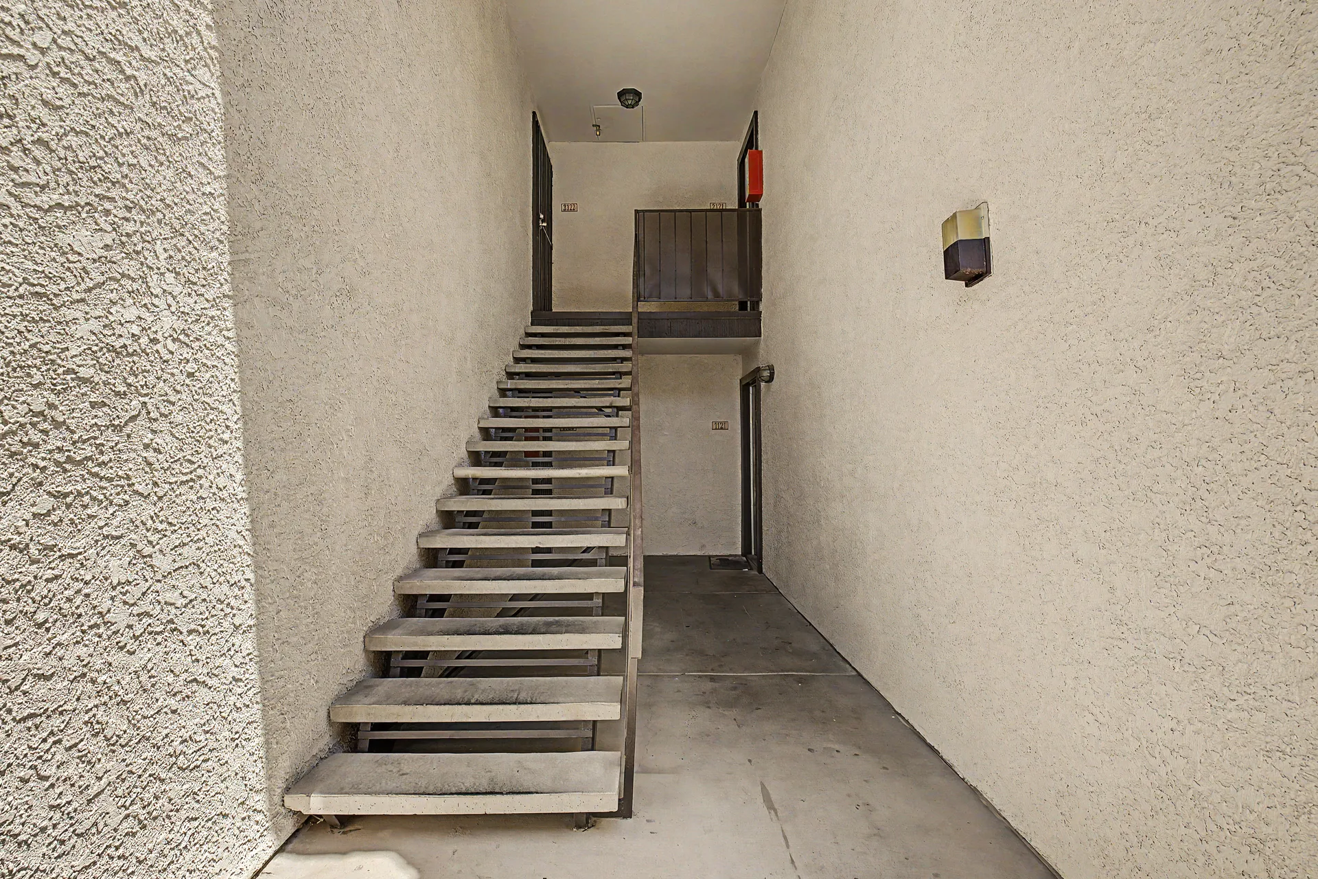 Covered stairway leading to upper-level units