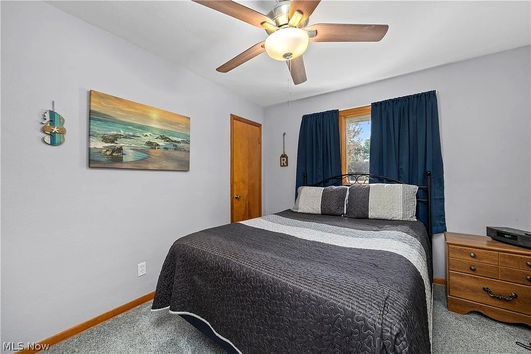 Guest bedroom with light grey walls, white trim, and grey carpeting