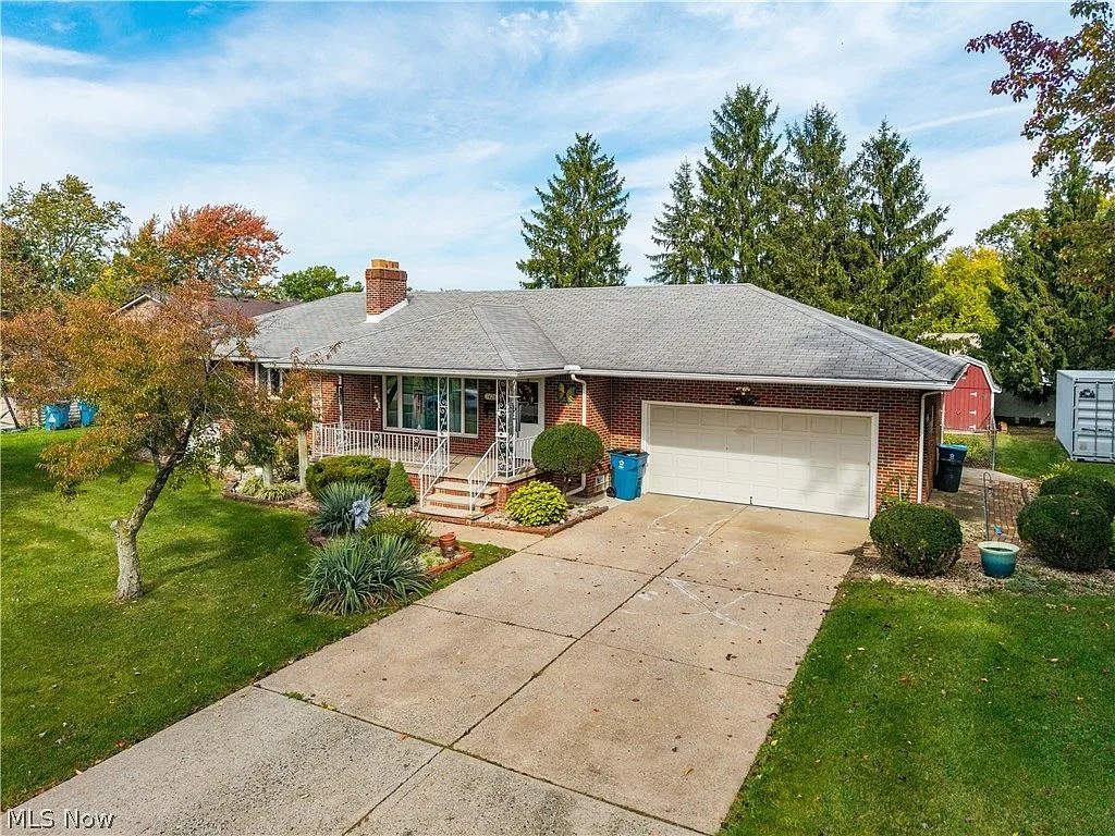 Front facade of the brick ranch home at 1426 W 40th St with attached garage and manicured lawn