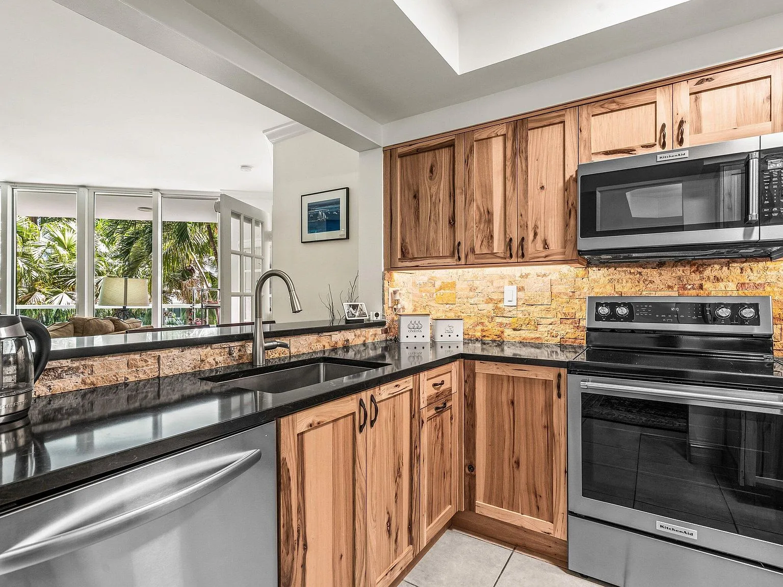 Kitchen with warm wood cabinetry at the Townsend Place condo in downtown Boca Raton