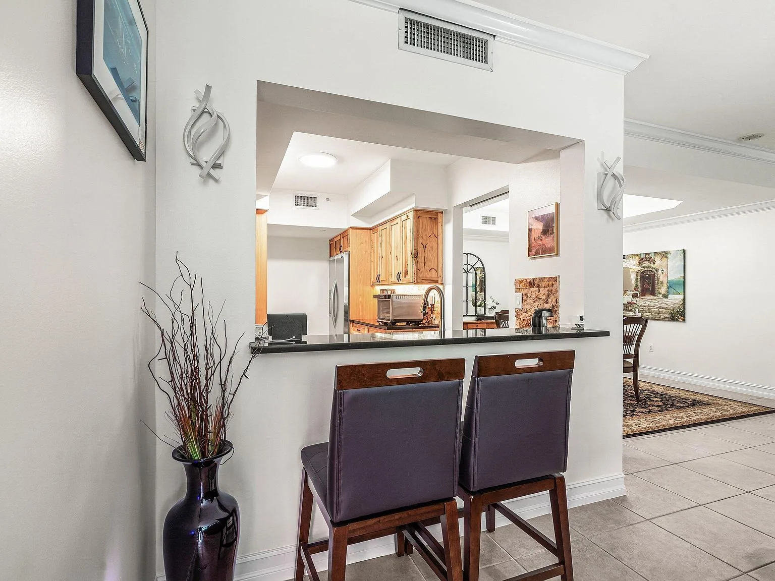 Kitchen breakfast bar with counter seating at 500 SE Mizner Boulevard #A209