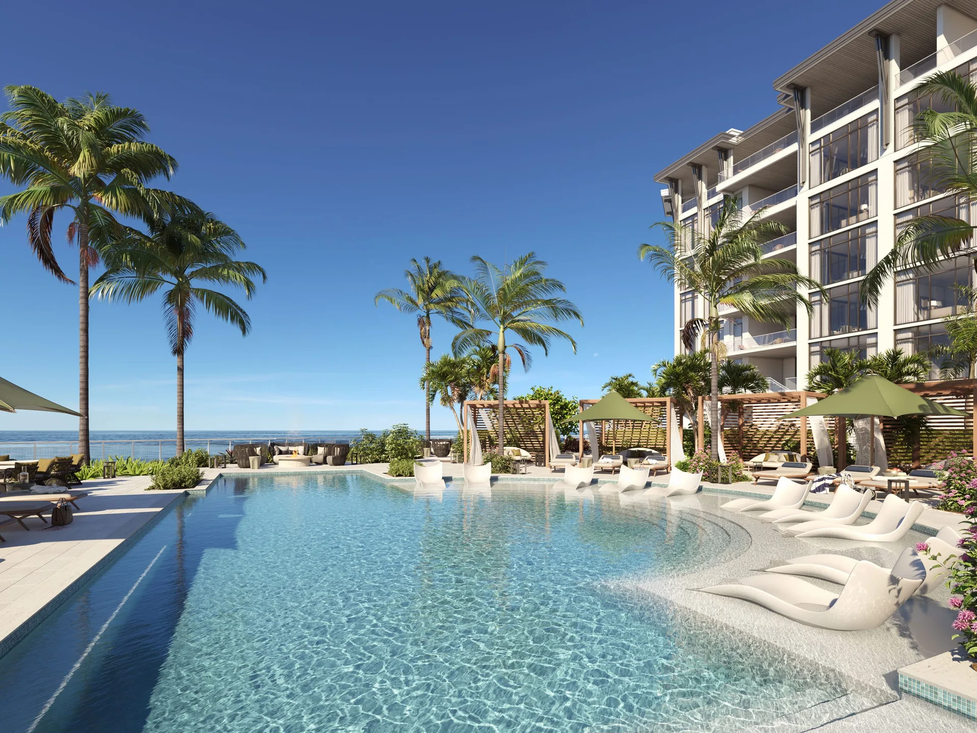 Terraza de piscina estilo resort en Rosewood Residences Naples con tumbonas, cabanas, sombrillas y una torre residencial alta al fondo