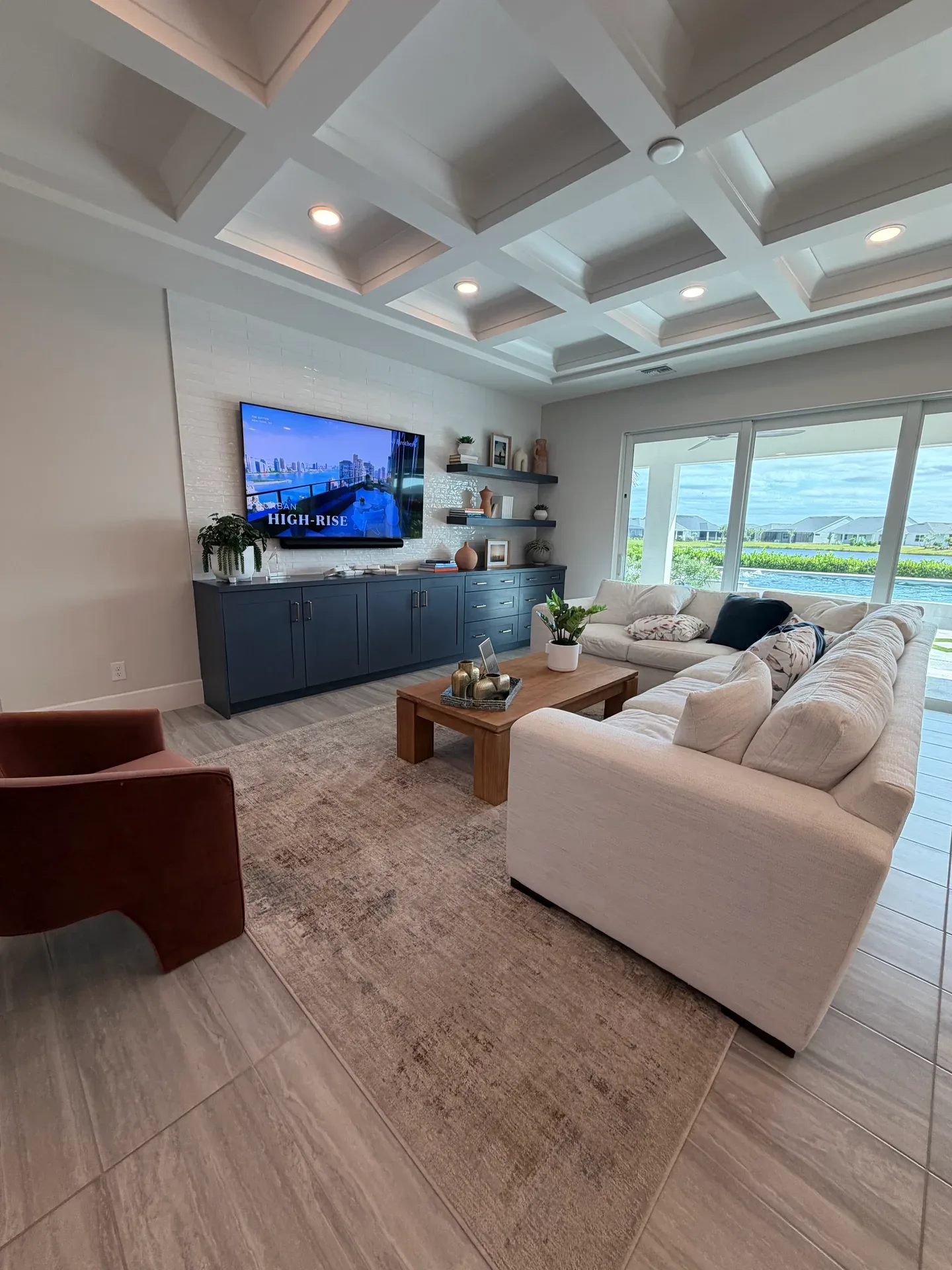 Living room with a coffered ceiling in a Regency at Babcock Ranch home