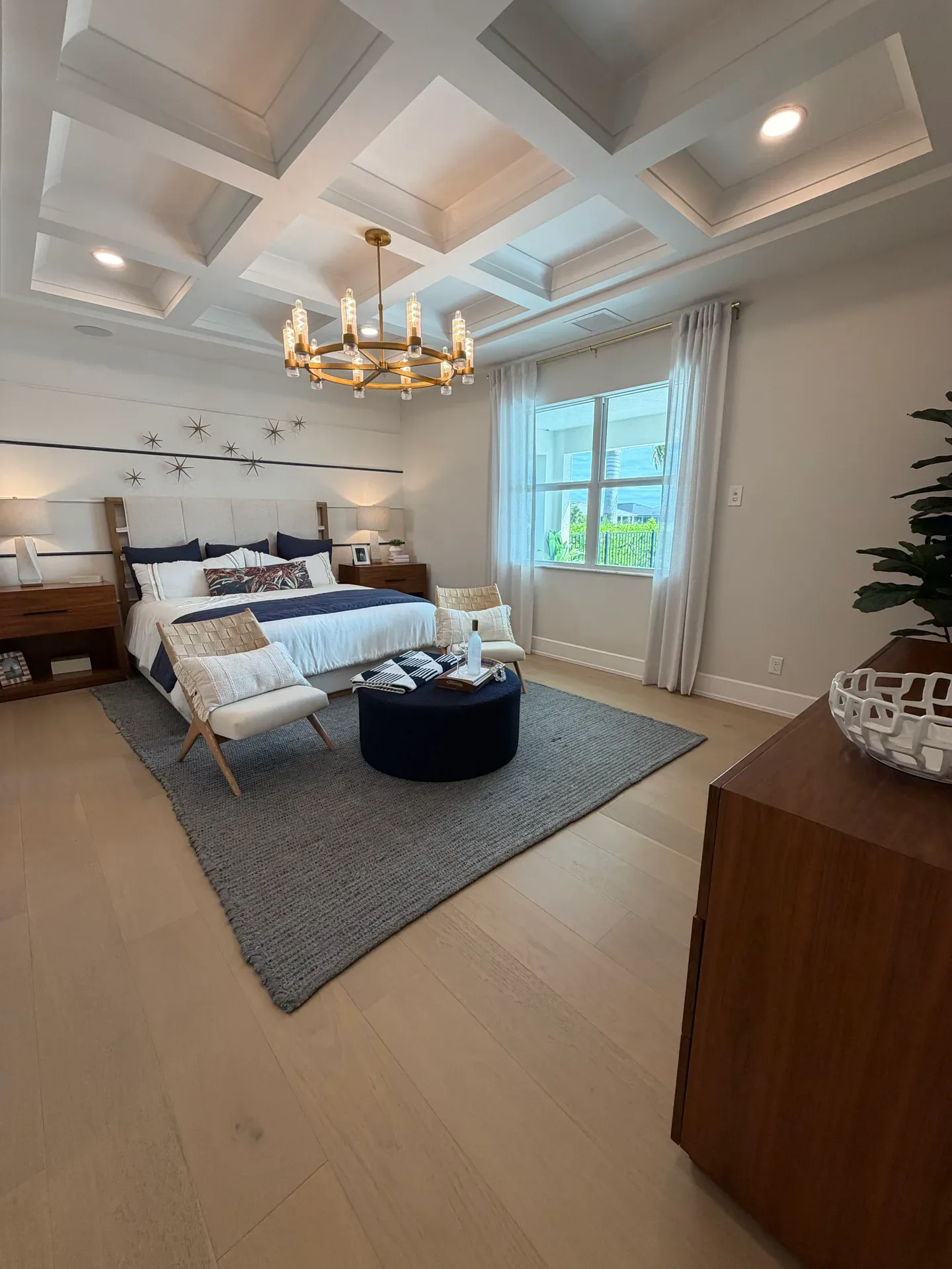 Primary bedroom with a coffered ceiling in a Regency at Babcock Ranch home