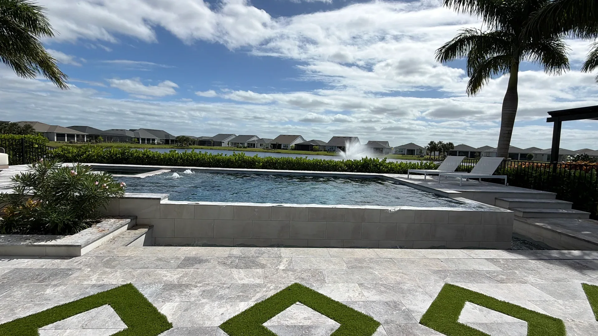 Backyard pool and lanai at a Regency at Babcock Ranch home with a lake view behind it