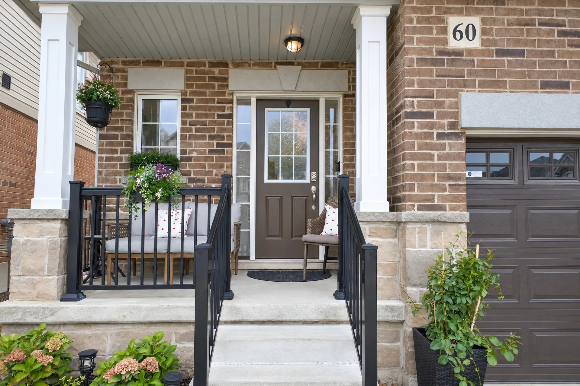 Front porch and entry: Covered porch, white columns, dark front door