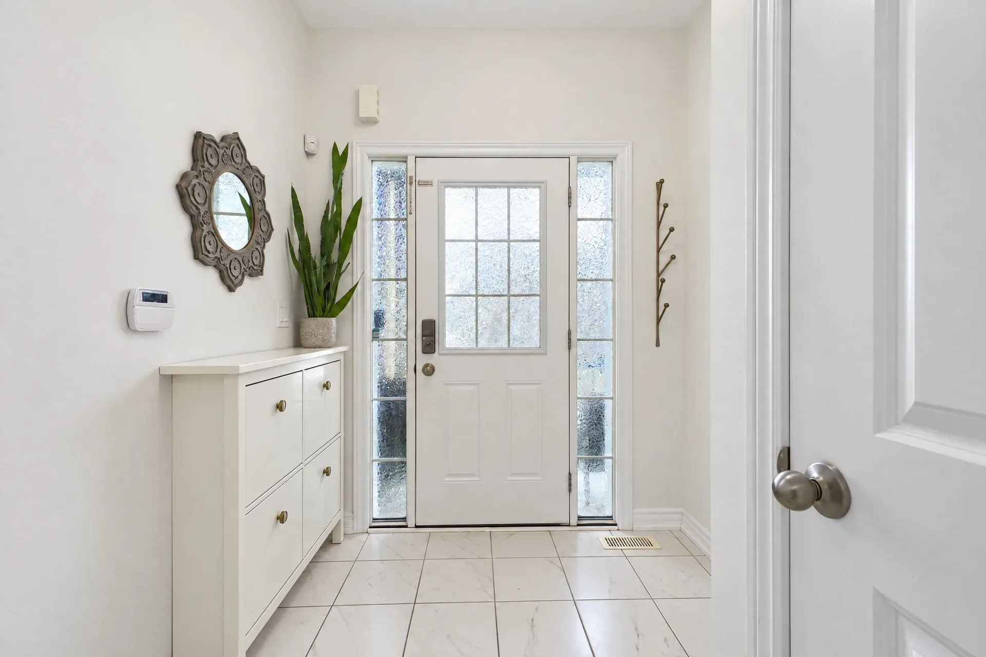 Entry foyer: Bright foyer with sidelights and tiled floor