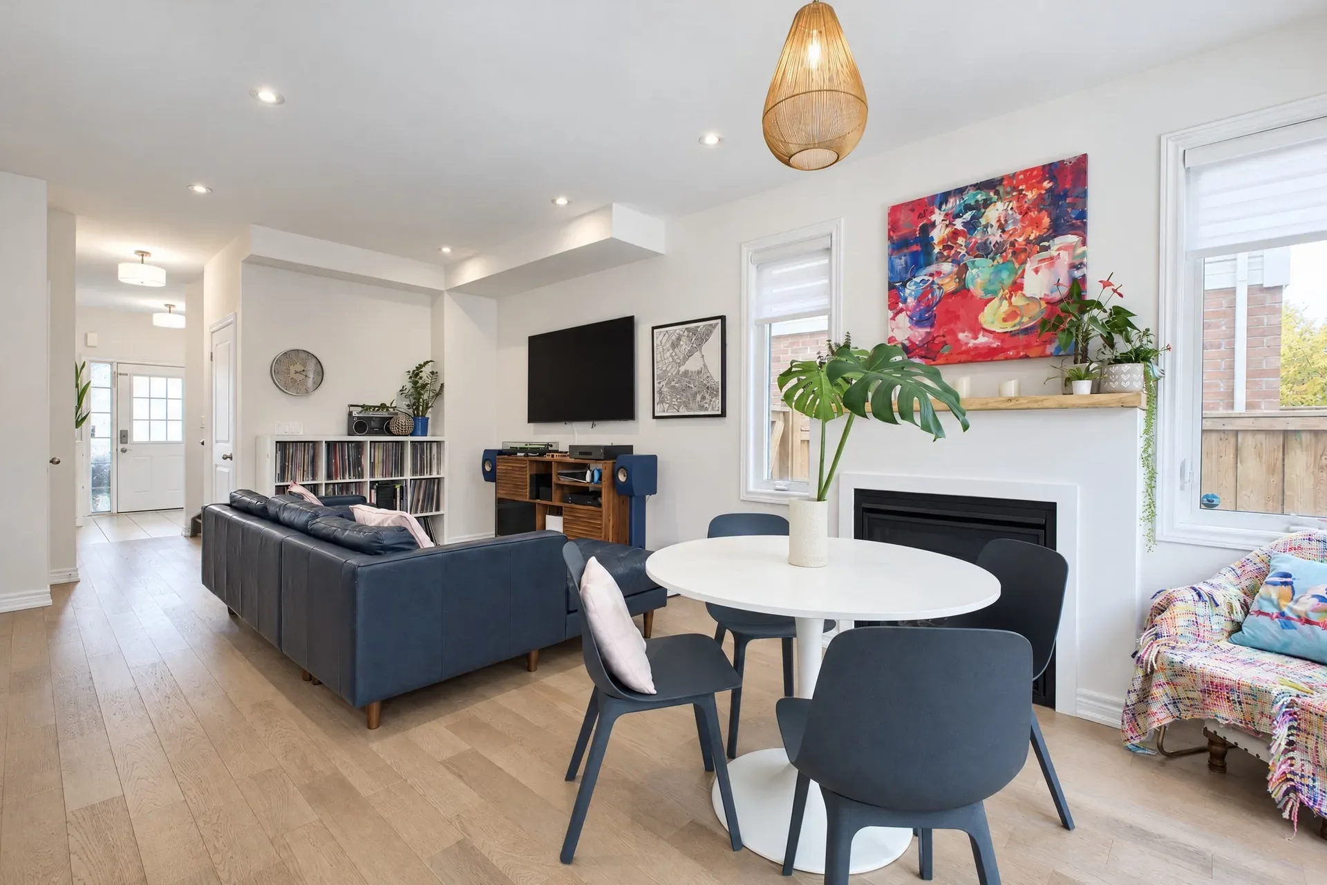Living and dining: Open living and dining anchored by the fireplace