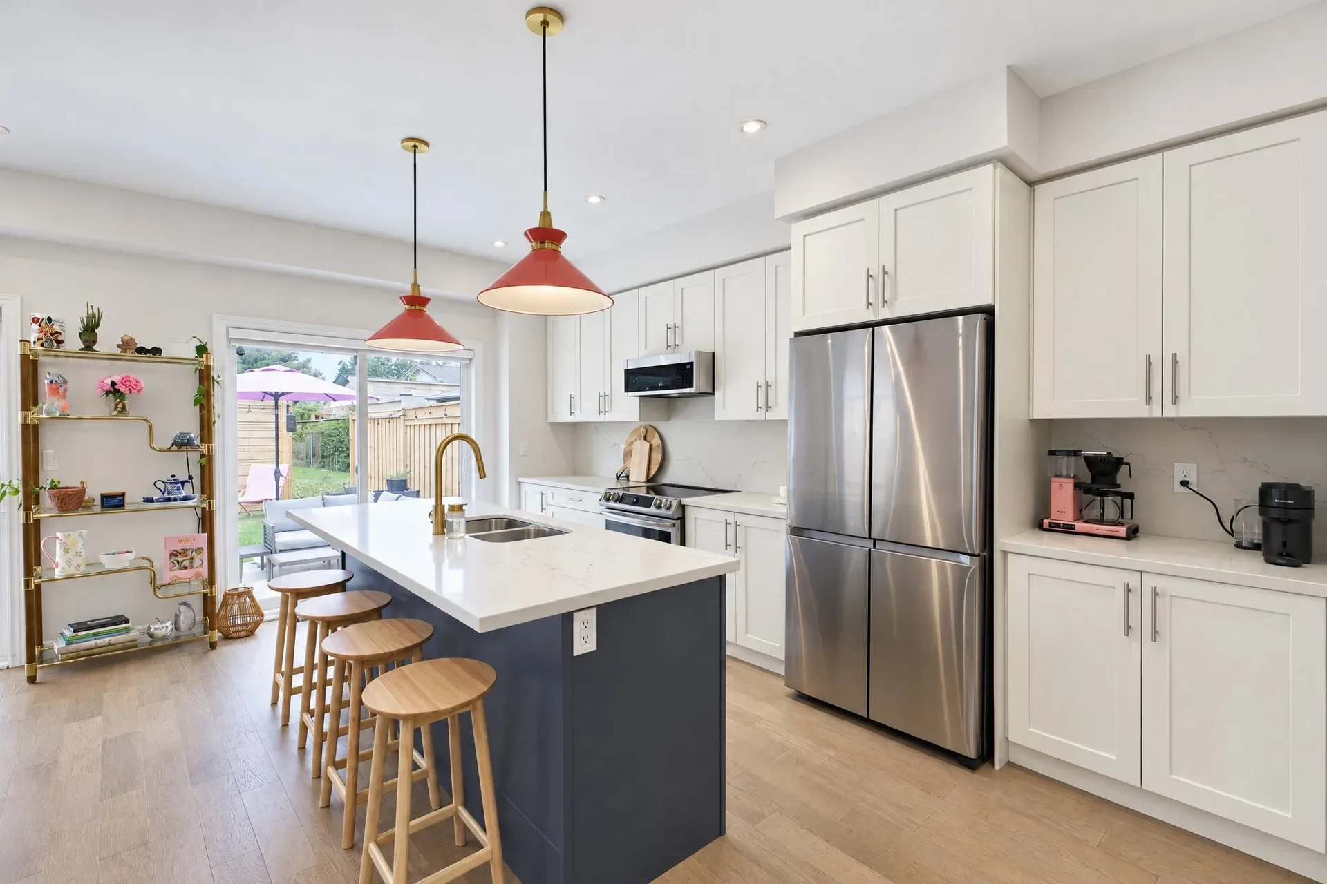 Kitchen and island: White cabinetry, quartz counters, stainless appliances
