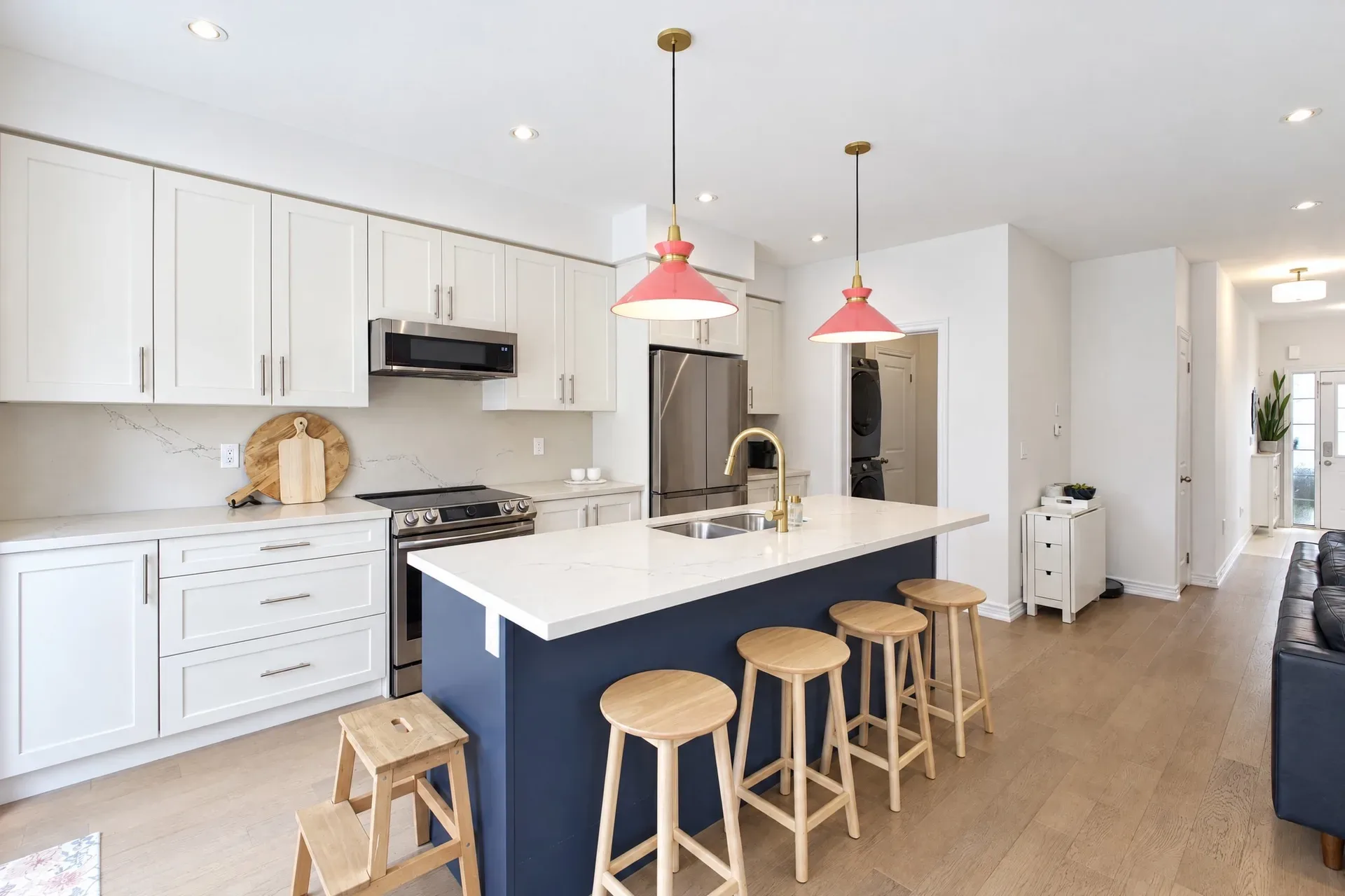 Navy kitchen island with quartz countertop and white cabinetry