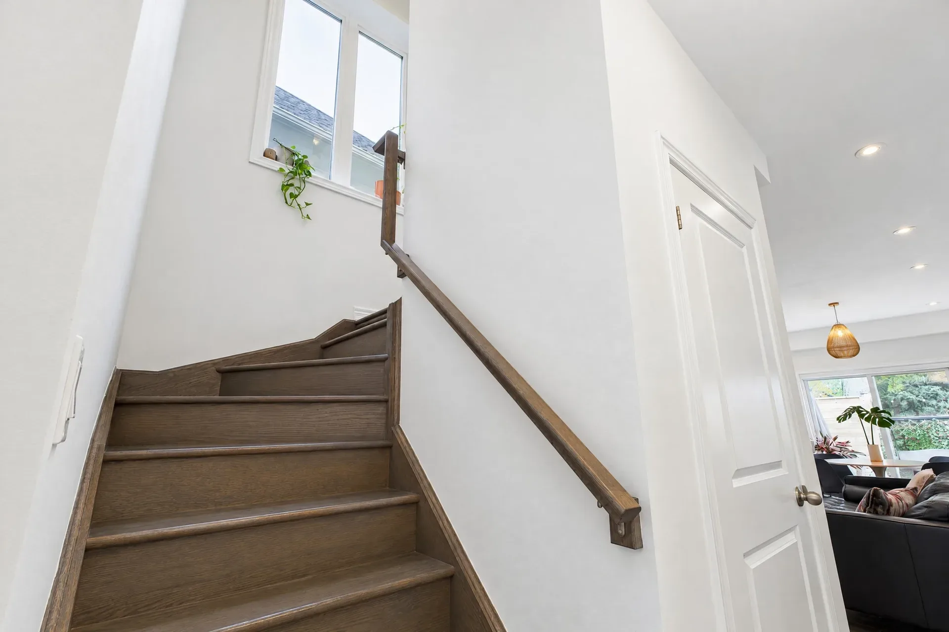 Staircase and landing: Wood staircase with a high, bright window