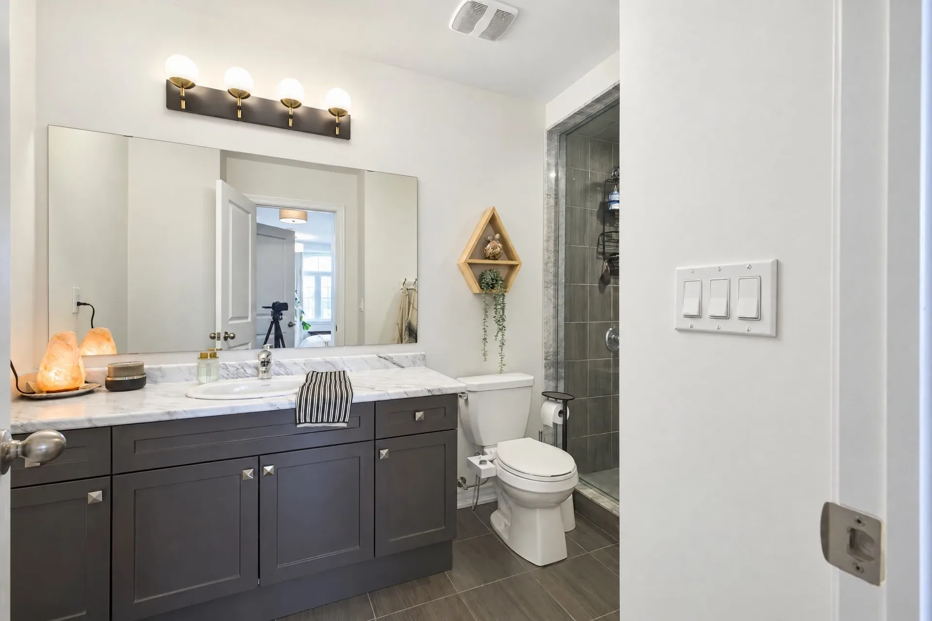 Ensuite vanity: Dark shaker vanity, stone counter, glass shower