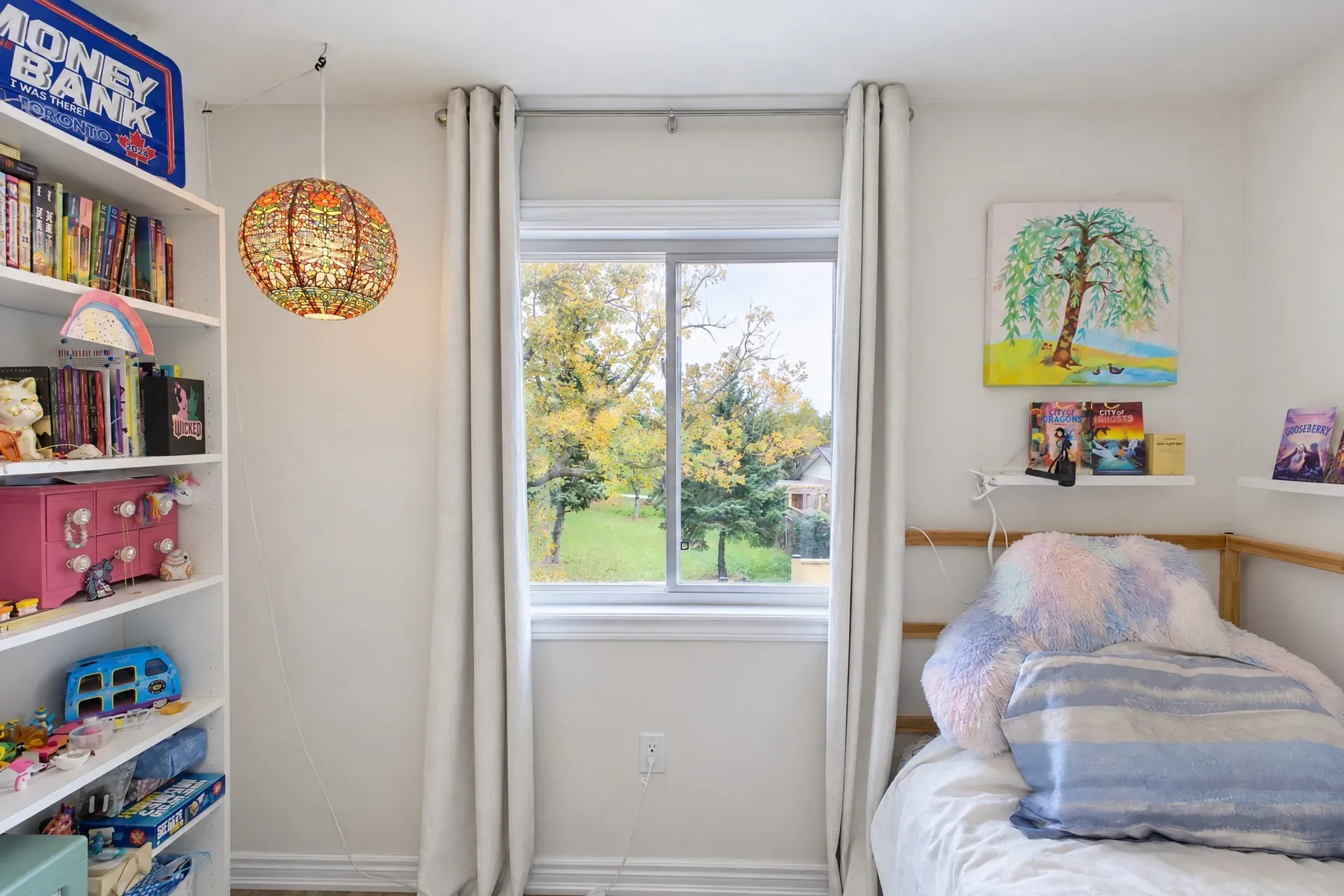Cozy secondary bedroom: Light-filled room with shelving and storage