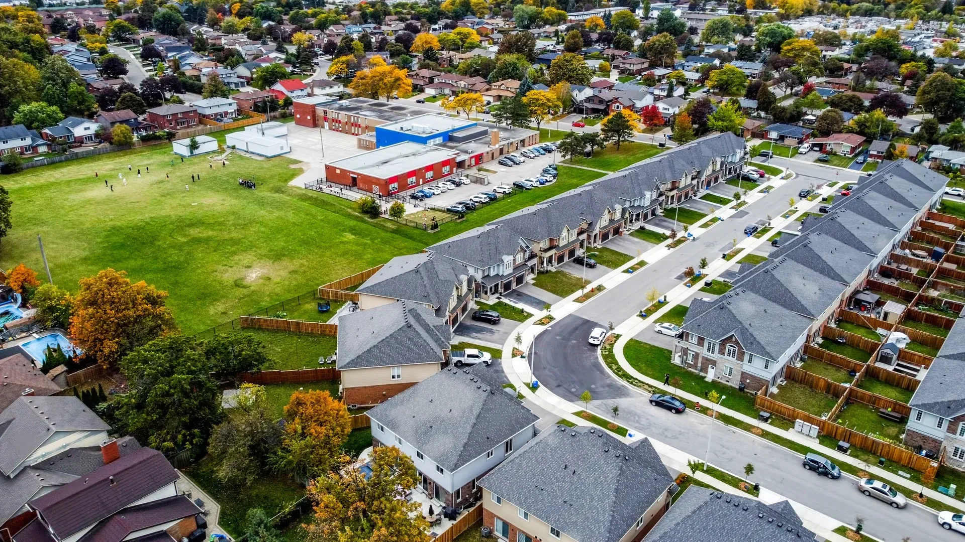A quiet tree-lined street of brick townhomes in Bruleville, Hamilton