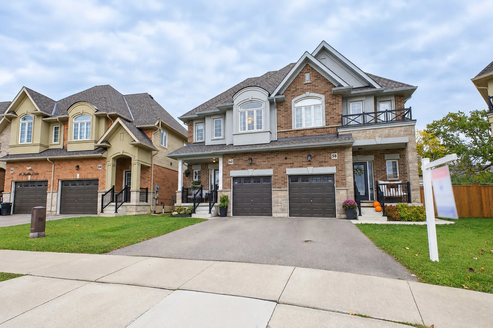 Front facade, street level: Brick and stone townhouse with attached garage