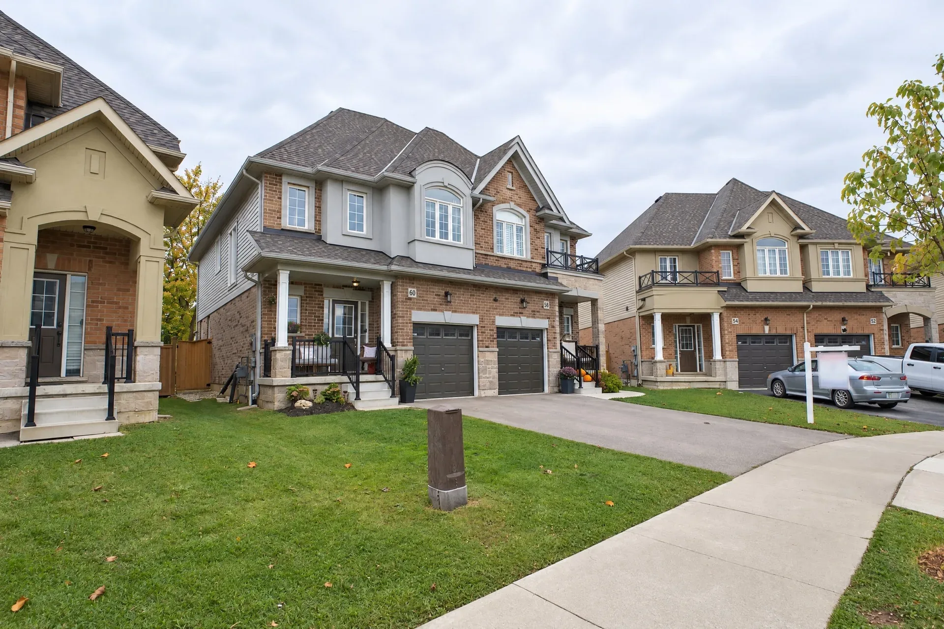 Front elevation: Brick and siding, multi-gabled roof, double garage