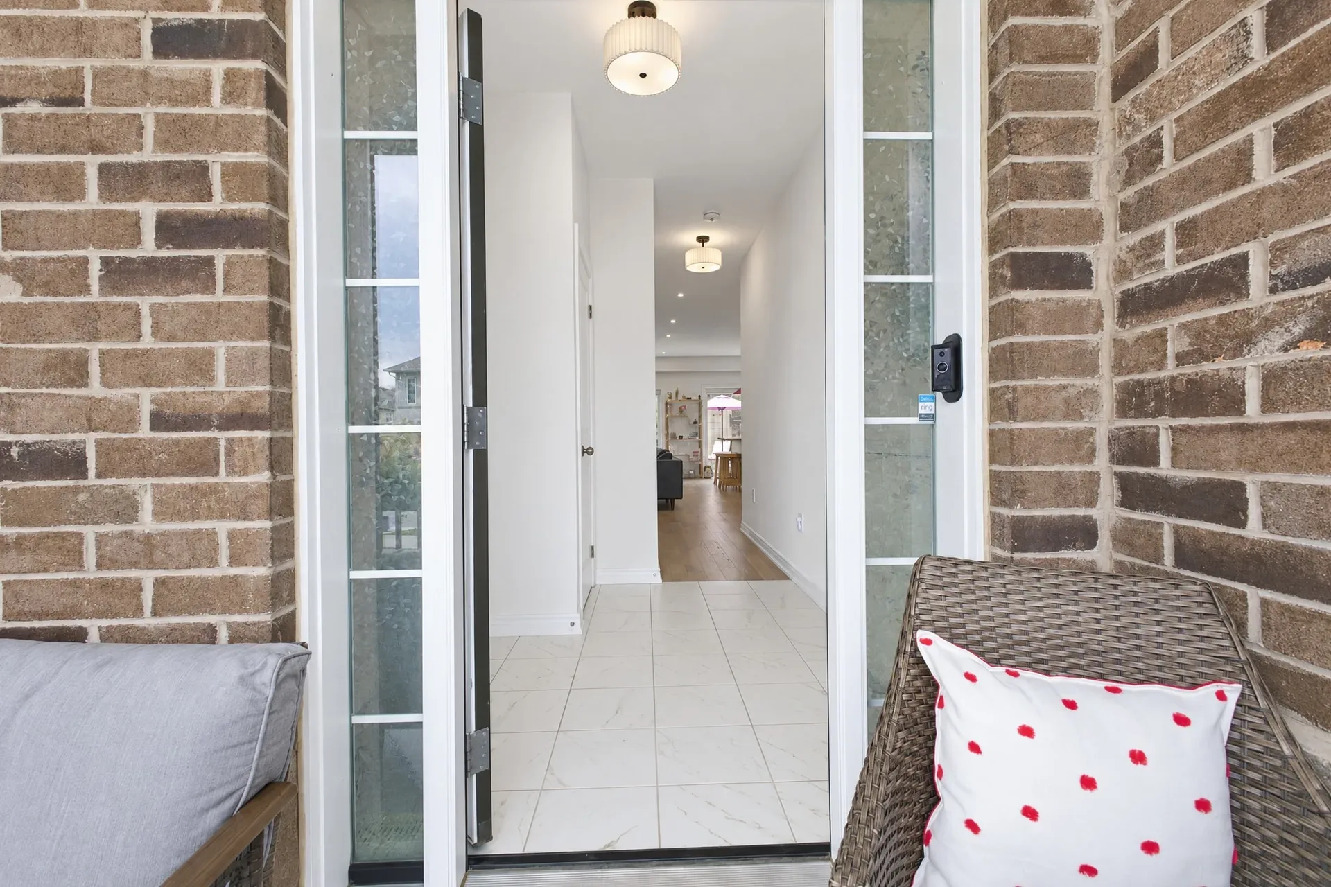 Porch to foyer: Covered porch looking into the bright entry