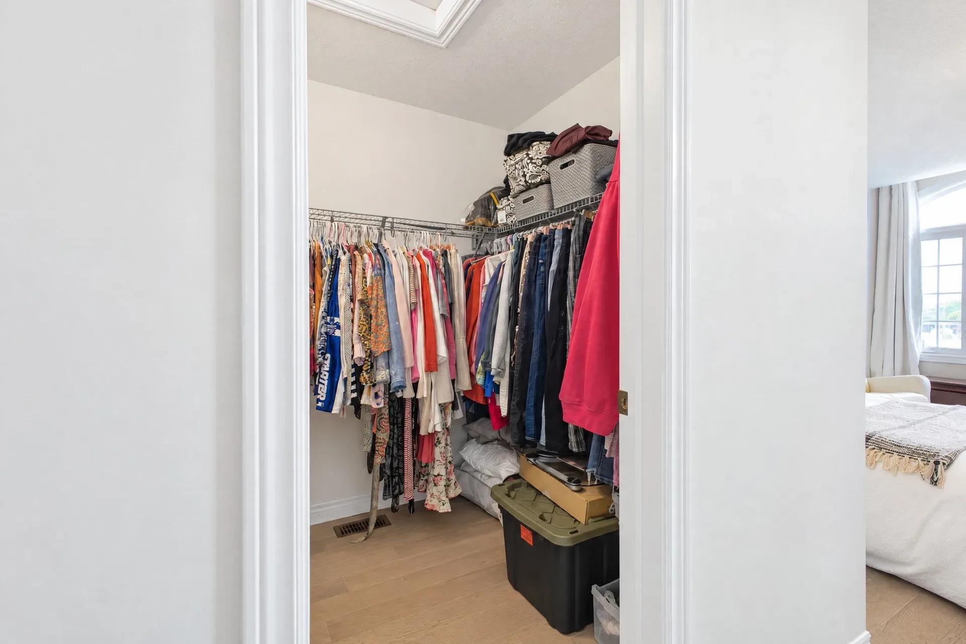 Primary walk-in closet: Plenty of hanging and shelf space