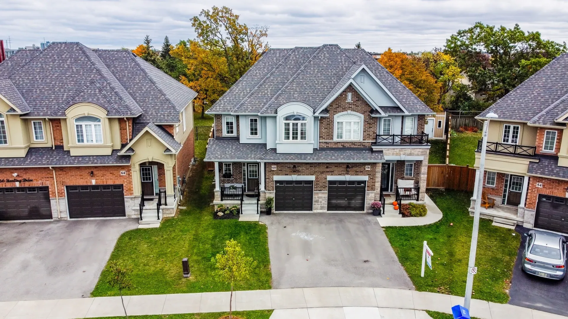Aerial front view: Roof, driveway and garage from above