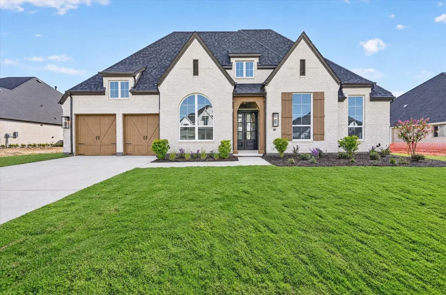 Modern brick facade of the Highland Homes 274 plan model at Pecan Square in Northlake, Texas