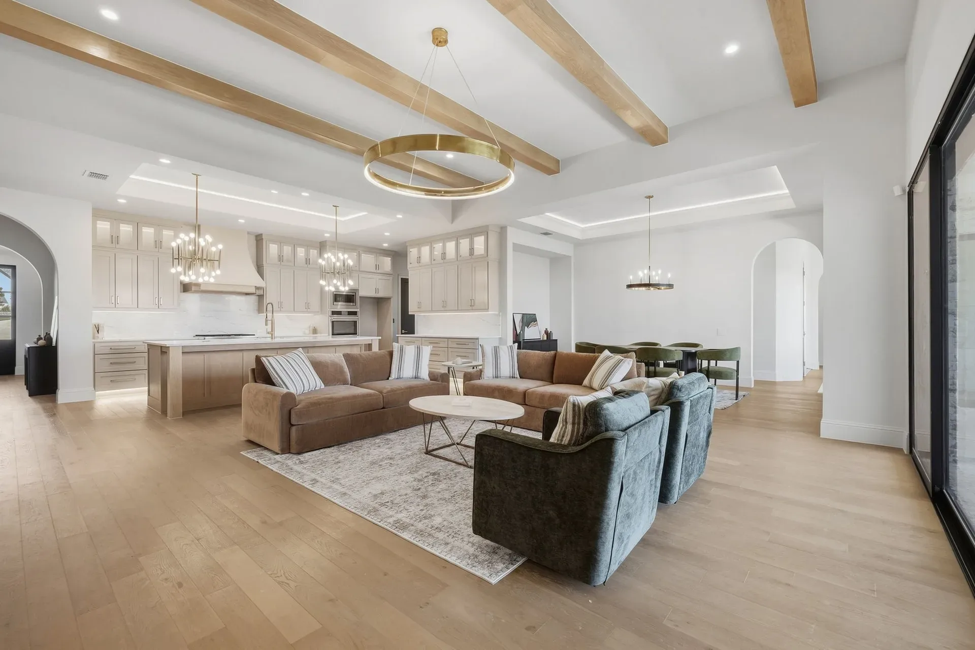 Real photo of a staged open-concept living room and kitchen in a North Texas home