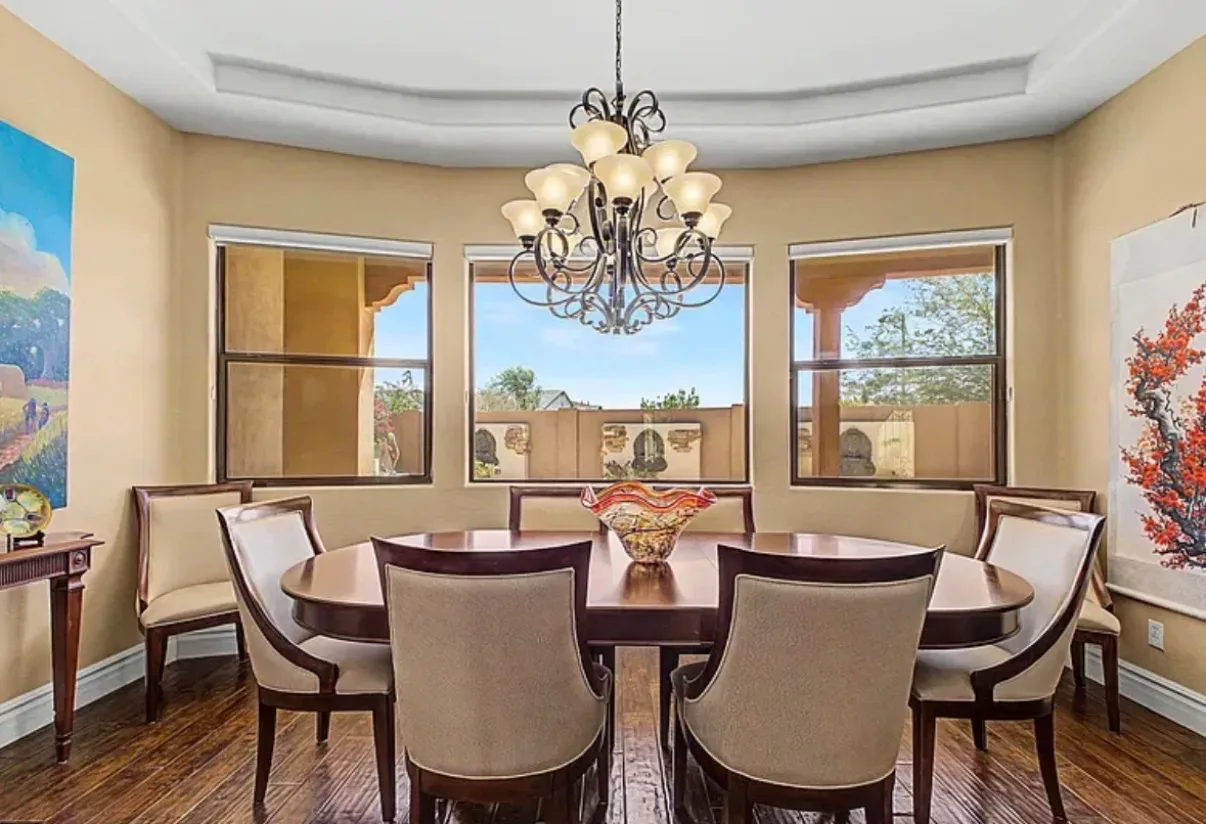 Formal dining room with a tray ceiling and hardwood floors