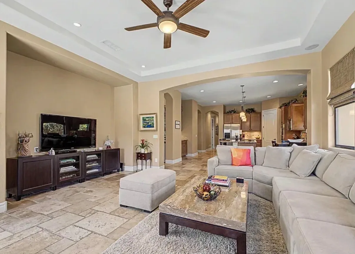 Open-plan living room with a sectional and stone-top coffee table