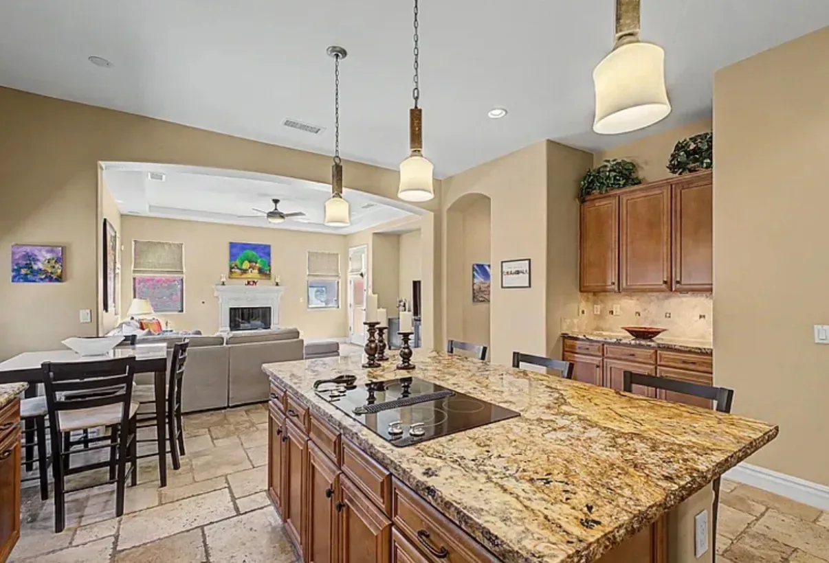 View from the kitchen island toward the living room and fireplace