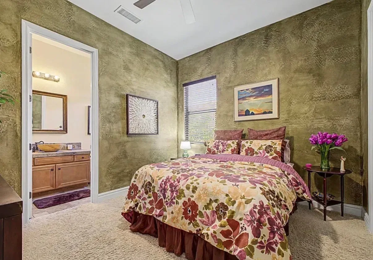 Bedroom with textured walls and a connecting bathroom
