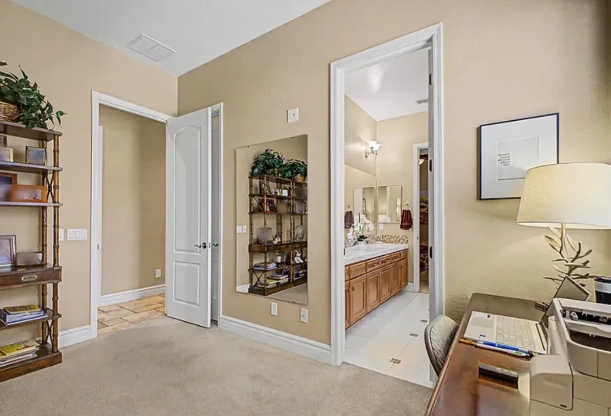 Home office space leading into a bathroom