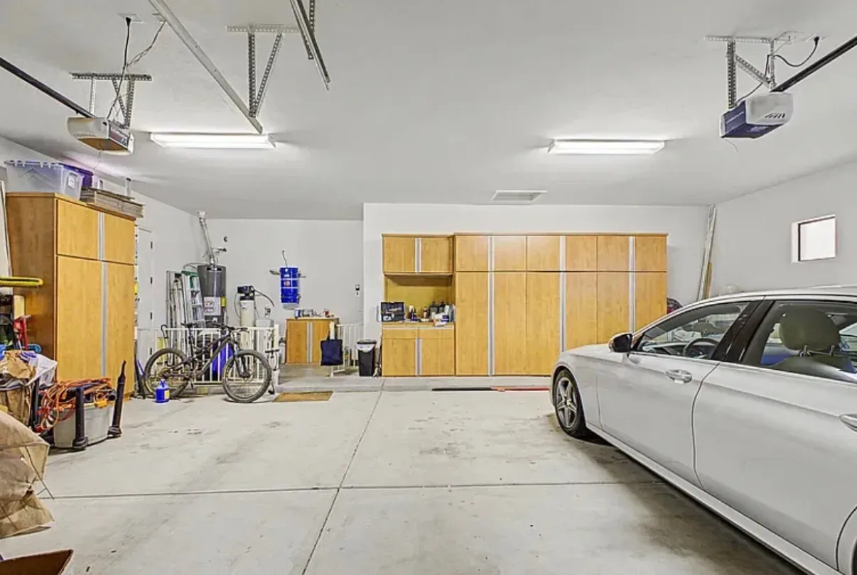 Multi-car garage with built-in wood cabinetry