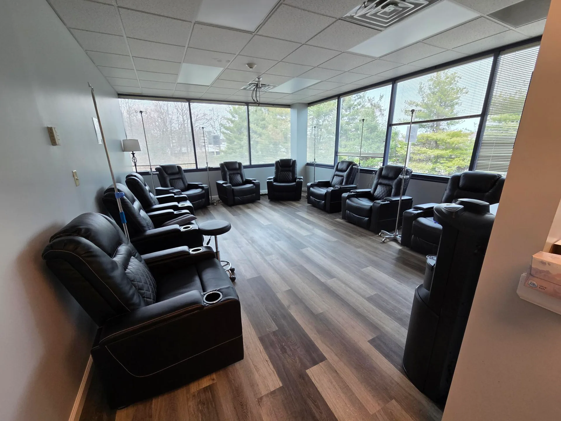 The IV therapy lounge at APRM Solutions with reclining chairs and IV poles